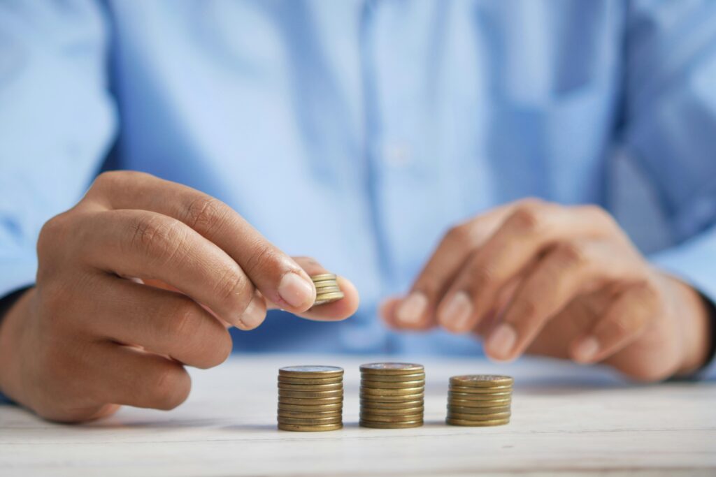 a person stacking coins on top of a table a person stacking coins on top of a table